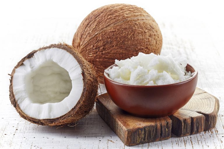 bowl of coconut oil and fresh coconuts